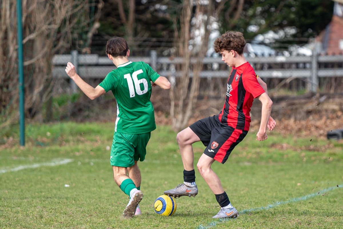 Lions player controlling the ball under pressure from Chipstead
